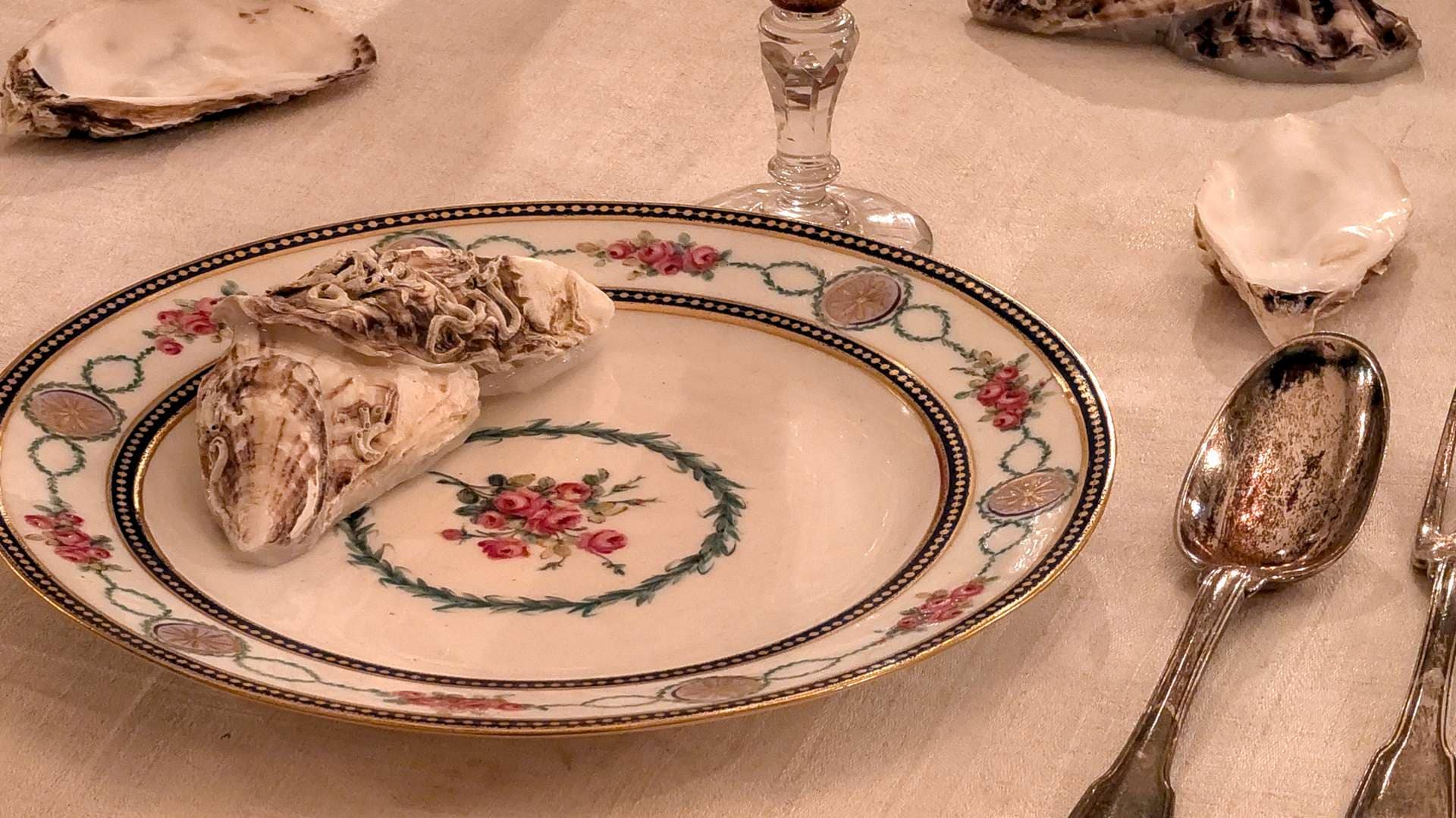 Close-up of a traditional French formal table setting and cutlery placement with Sèvres porcelain and oyster shells
