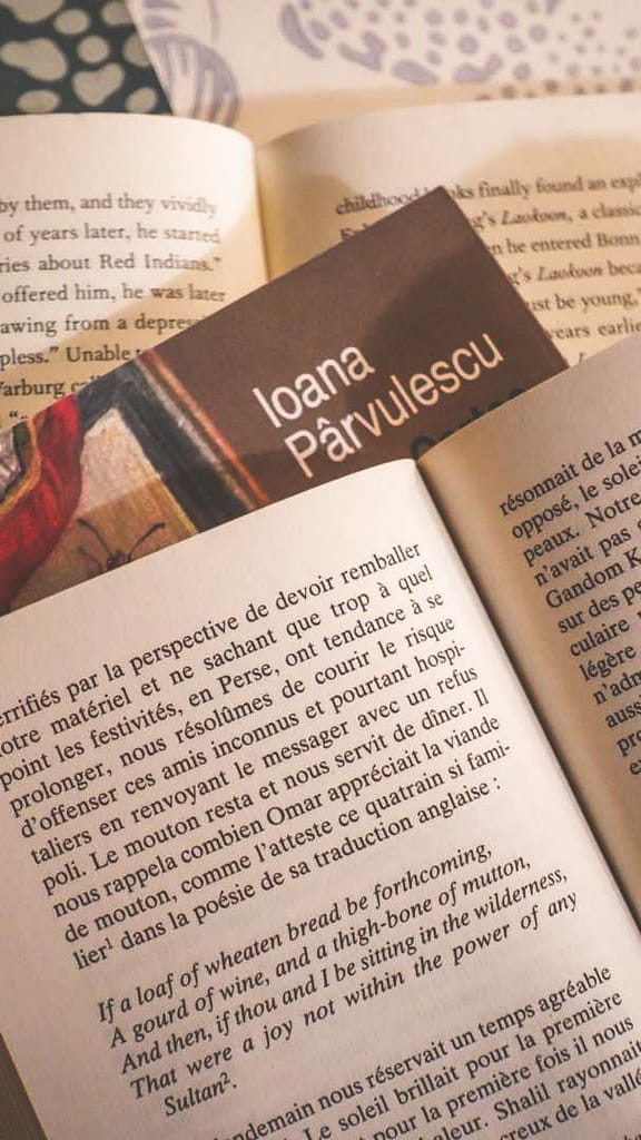 Close-up of open pages of stacked books, symbolizing the ritual of reading for mental well-being.