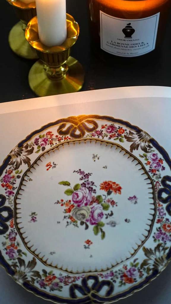 Close-up of an interior page showing a French porcelain plate made at Sèvres